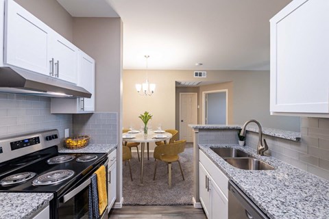a kitchen and dining room with a table and chairs