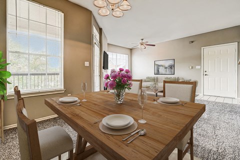 a dining room with a wooden table and chairs