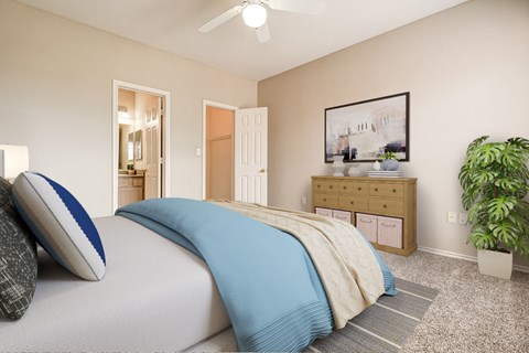 a bedroom with a bed and a plant and a ceiling fan