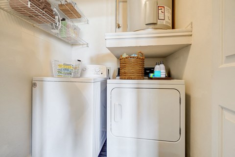 a small laundry room with two washes and a dryer