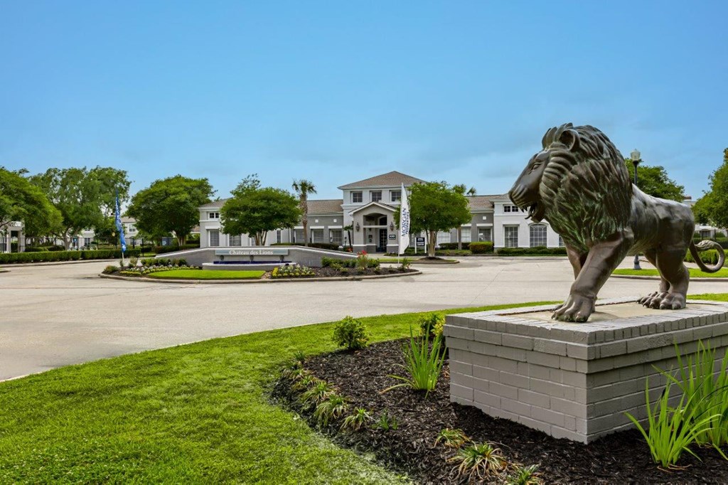 a sculpture of a lion in front of a house