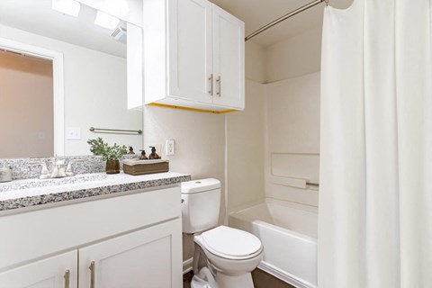 a white bathroom with a toilet and a sink