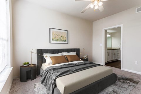 a bedroom with a bed and a ceiling fan