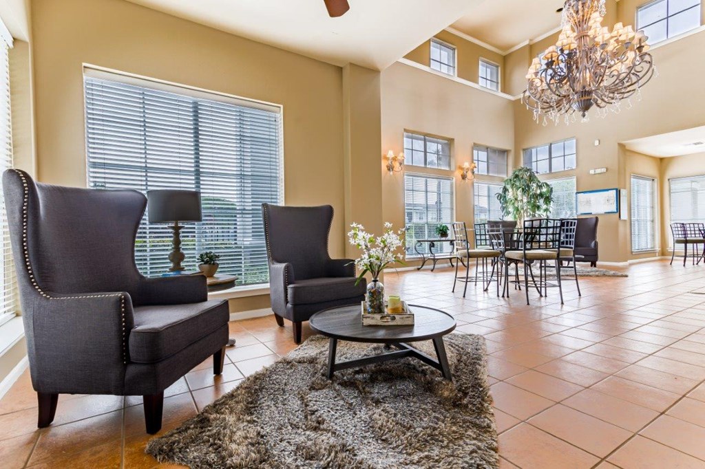 a living room with chairs and a table
