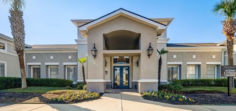 a building with a blue door and a palm tree