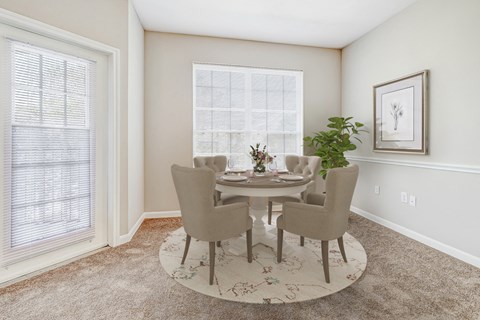 a dining room with a table and chairs and a window