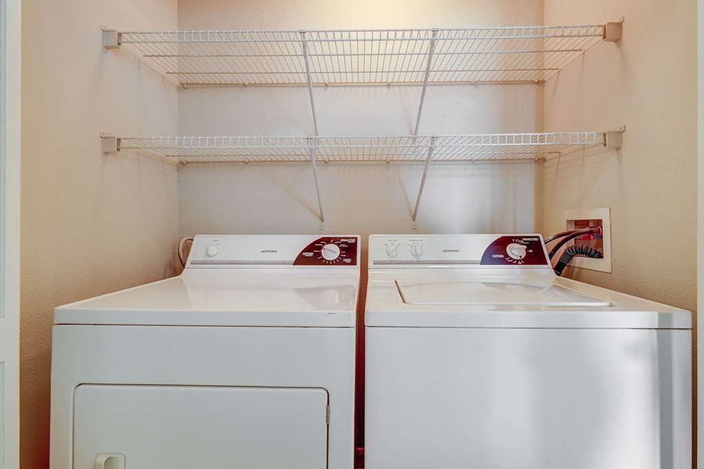 a laundry room with two washes and a dryer