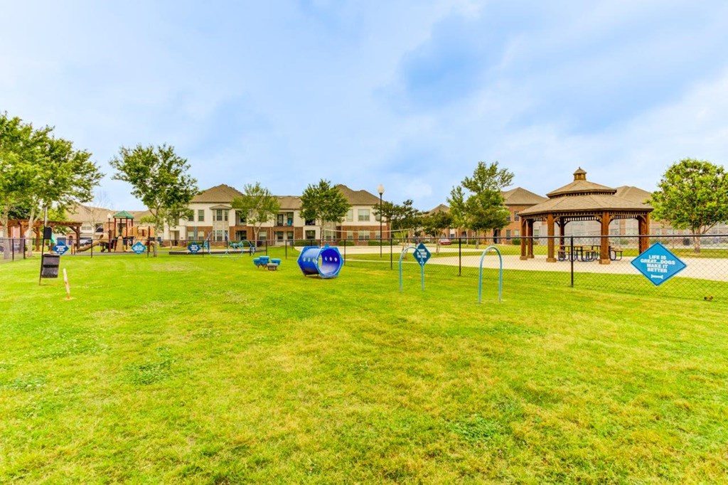 a park with agility courses and gazebo in the middle of a park
