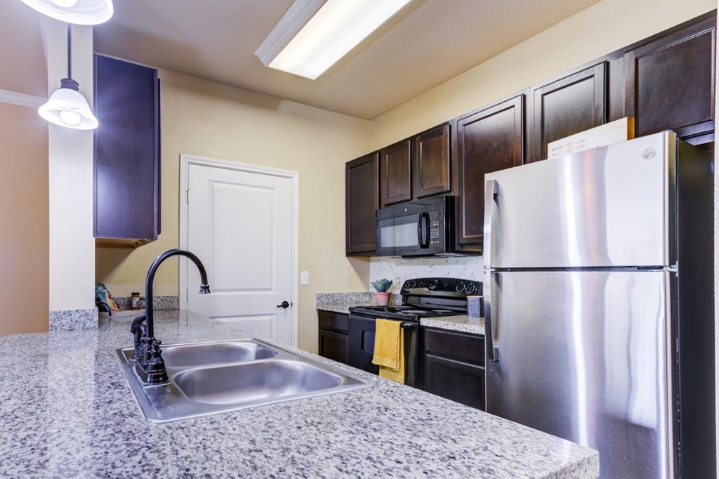 a kitchen with stainless steel appliances and granite counter tops