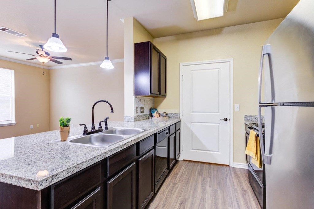 a kitchen with a sink and a refrigerator