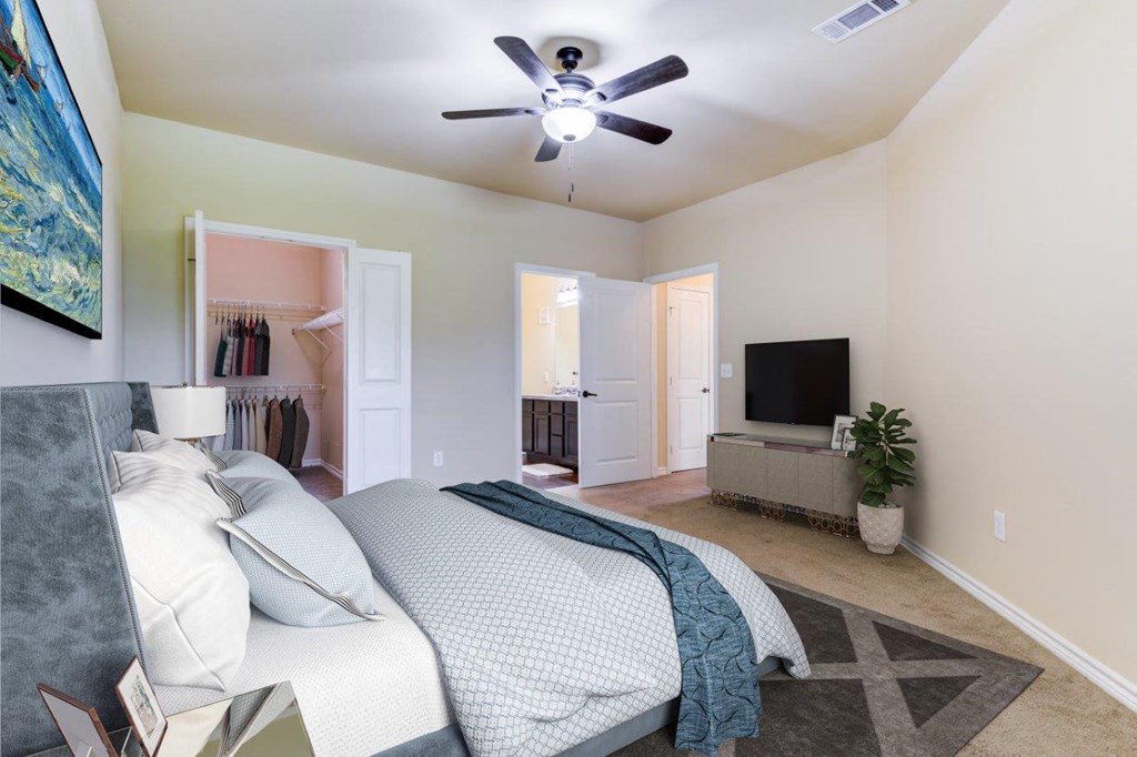 a bedroom with a bed and a ceiling fan