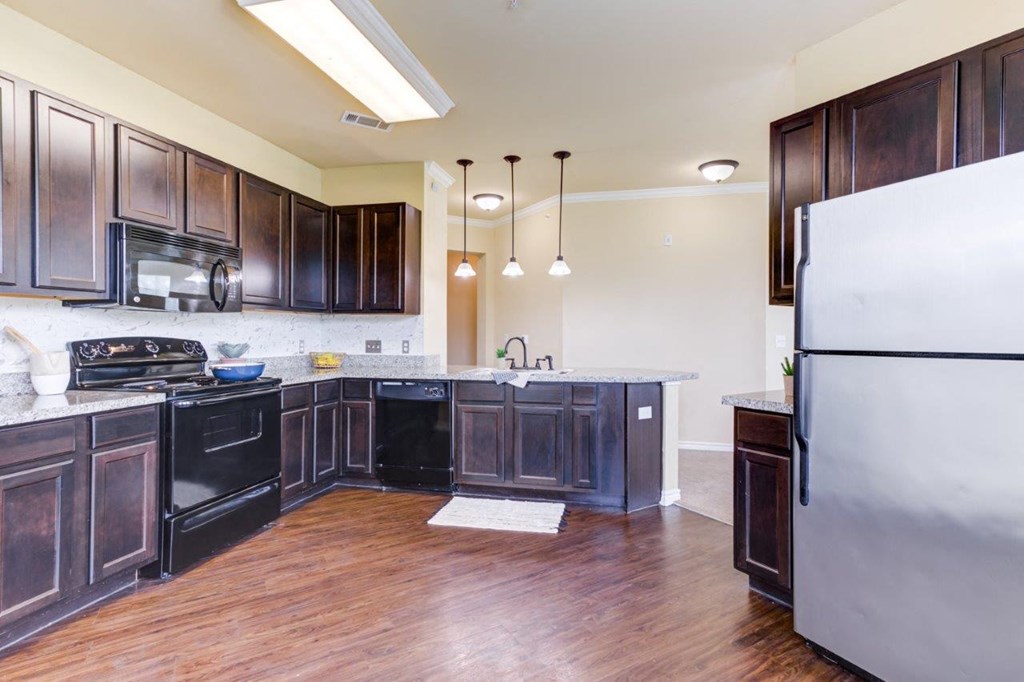 a kitchen with stainless steel appliances and wooden cabinets