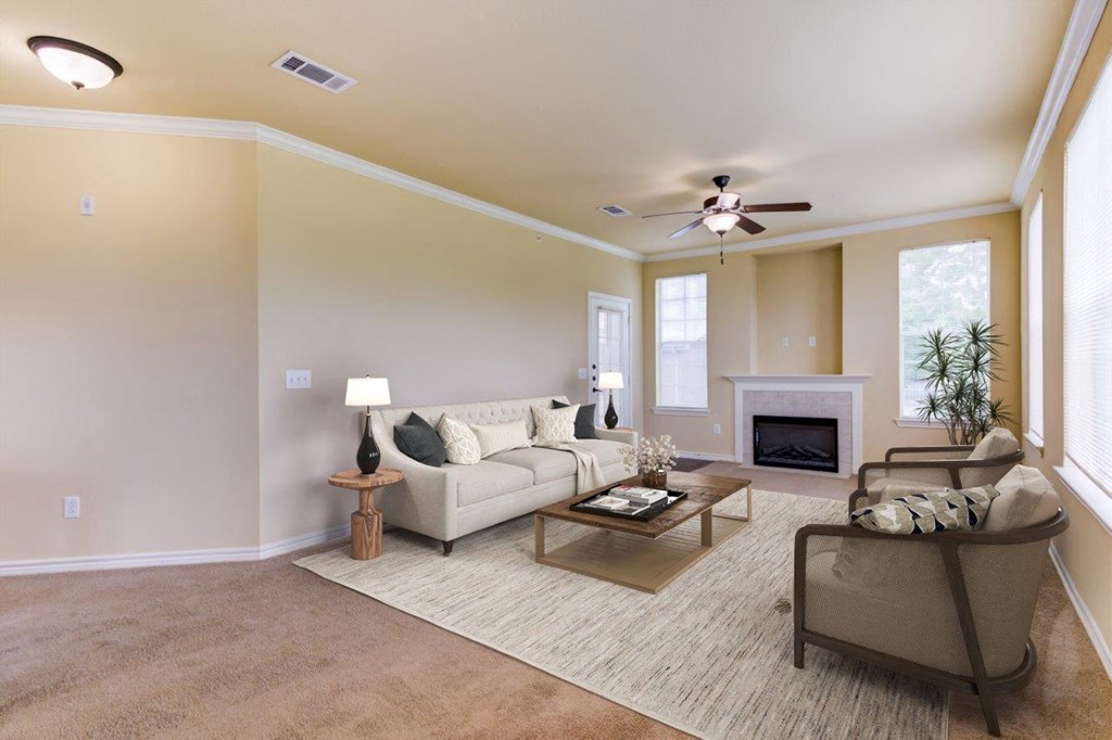 a living room with furniture and a ceiling fan