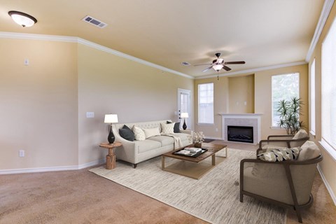 a living room with furniture and a ceiling fan