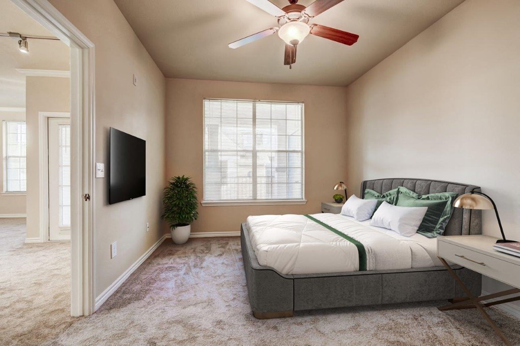 a bedroom with a ceiling fan and a bed