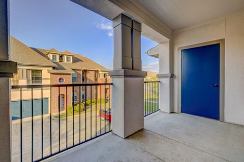 the entrance to a balcony with a blue door
