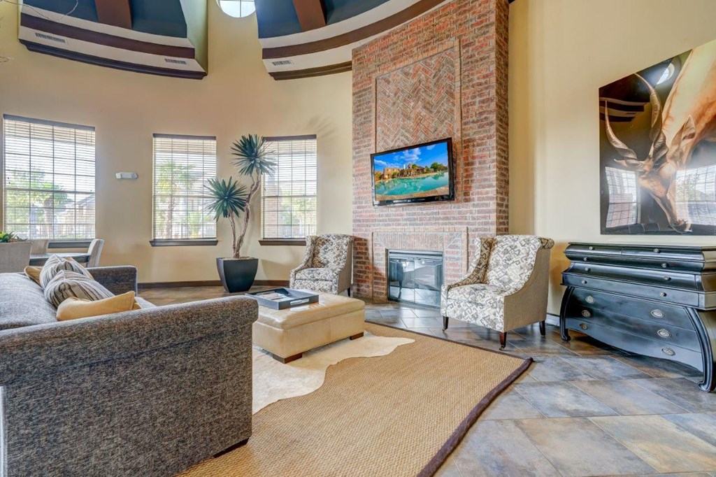a living room with couches and chairs and a fireplace