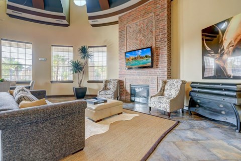 a living room with couches and chairs and a fireplace