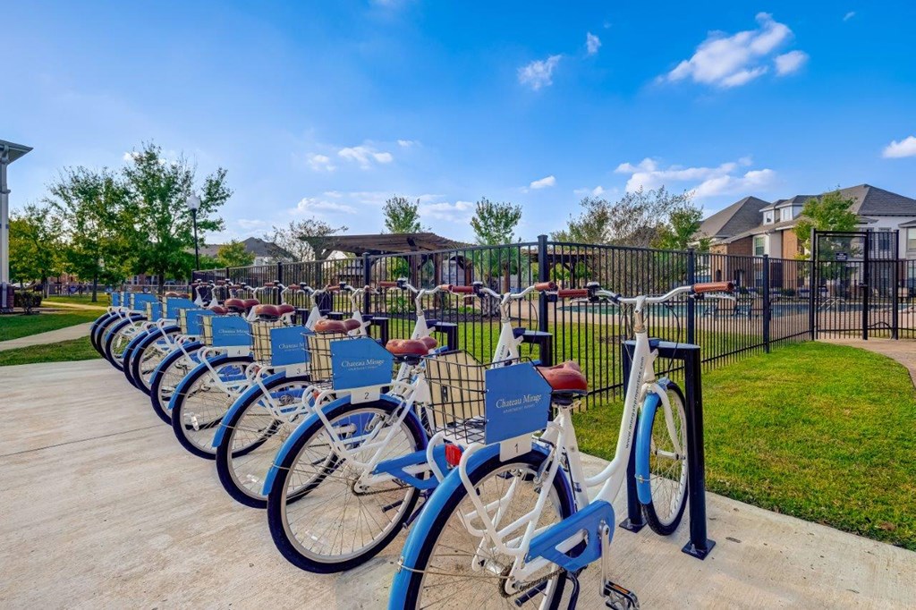a row of bikes parked in front of a park