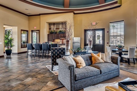 a living room with a couch and a table with chairs