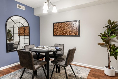 a dining room with a table and chairs