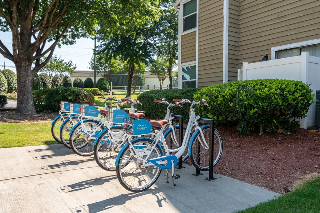 a row of blue bikes parked in front of a building