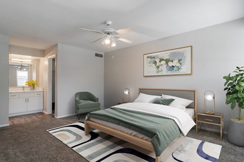 a bedroom with a bed and a ceiling fan