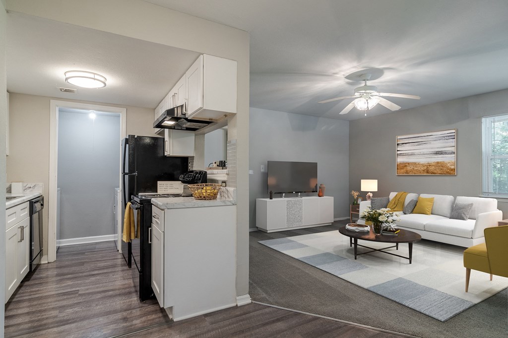 a kitchen and living room with a white couch and a table