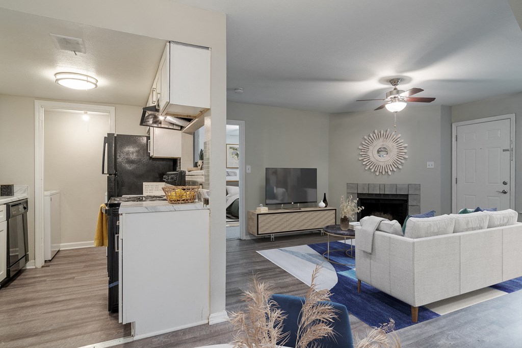 an open living room with a kitchen and a living room