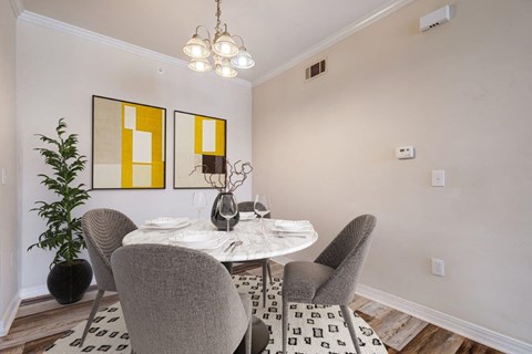 a dining room with a table and chairs