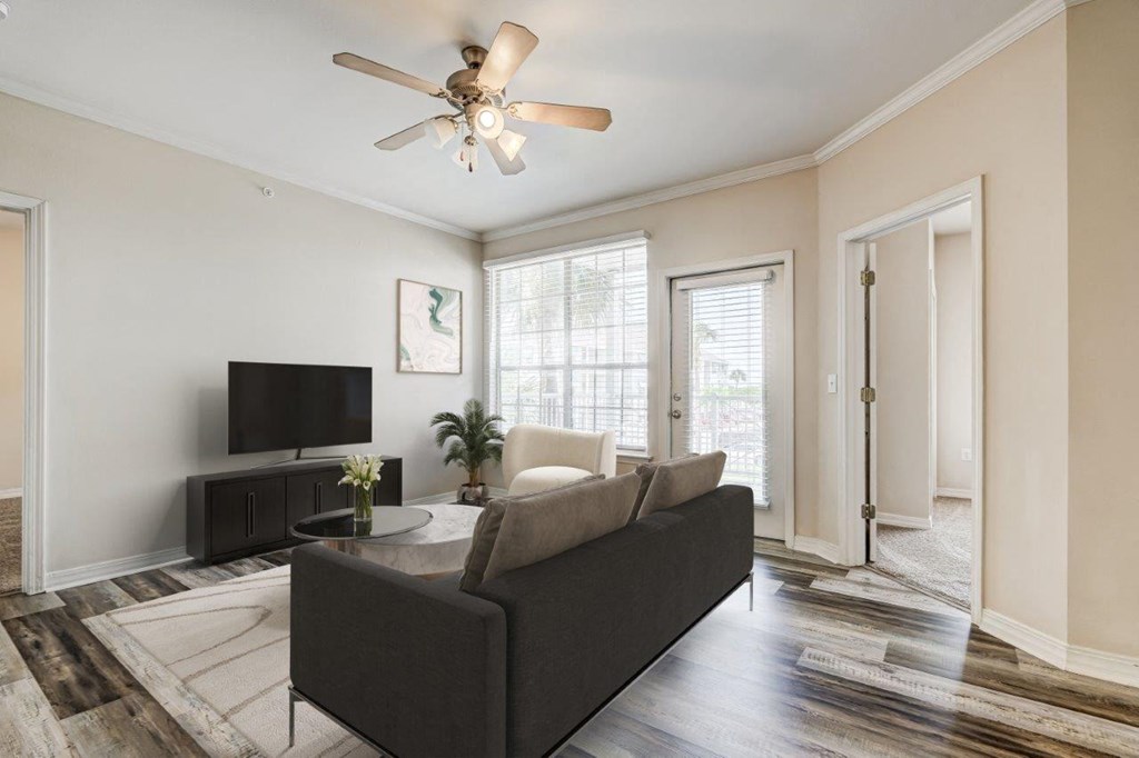 a living room with a couch and a ceiling fan