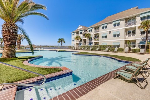 a large swimming pool with a building in the background