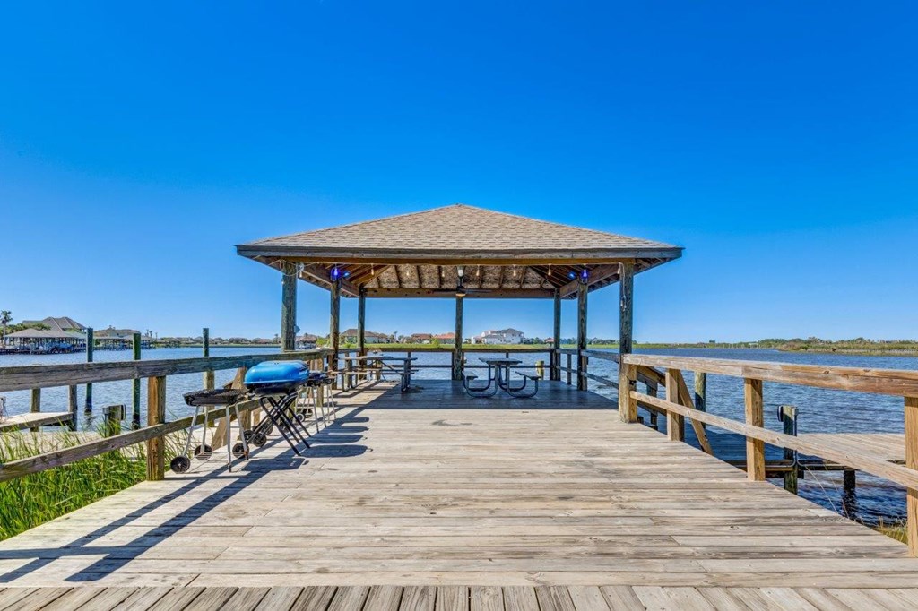 a dock with a gazebo on the water