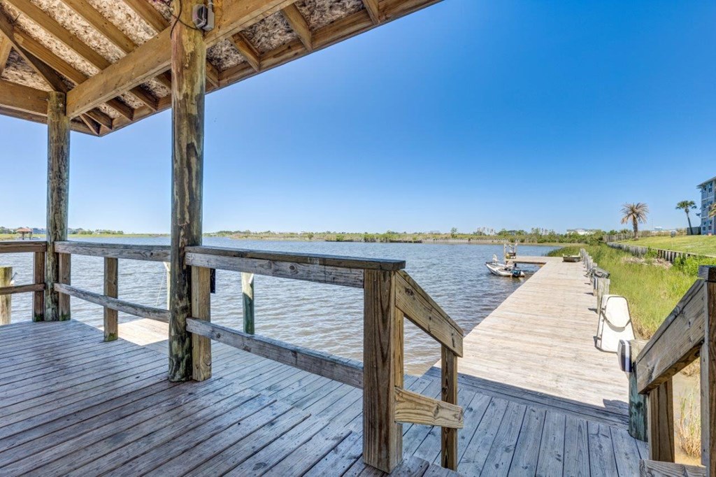 a dock with a boat in a body of water