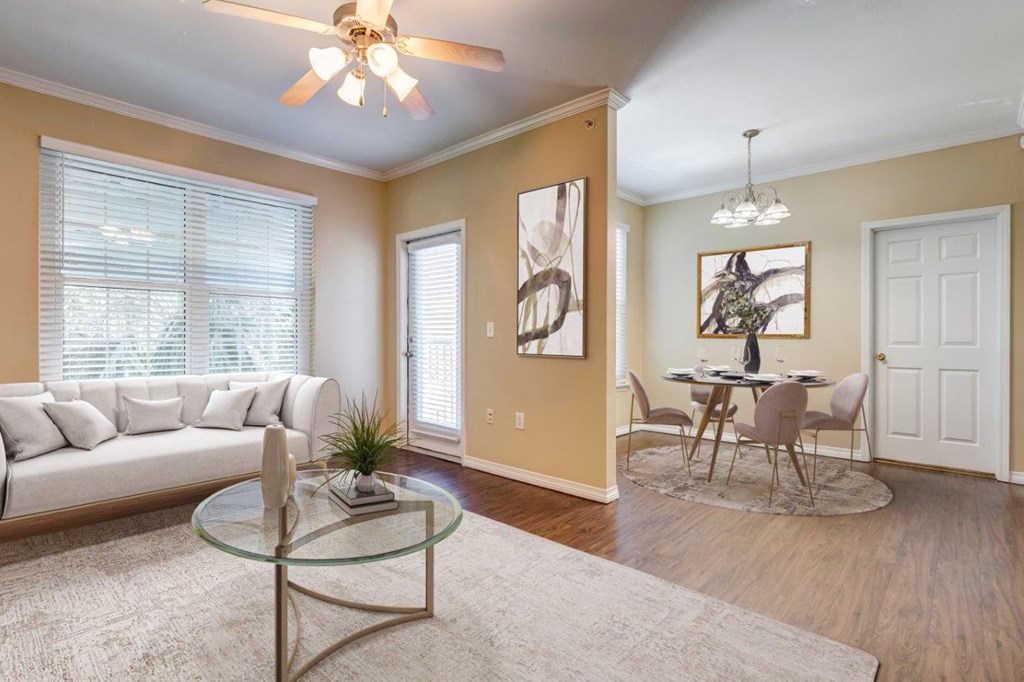 a living room with a couch and a table and a ceiling fan