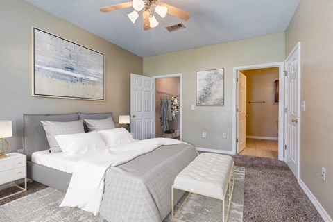 a bedroom with a bed and a ceiling fan