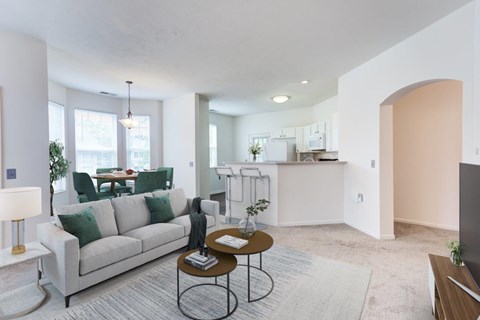 A living room with a grey couch and a coffee table.