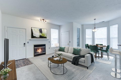 A modern living room with a fireplace and a dining area.