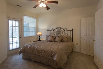 a bedroom with a bed and a ceiling fan