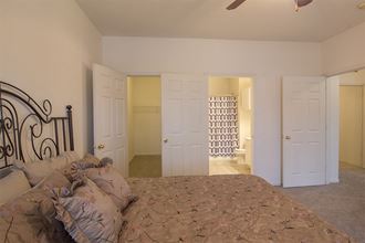 a bedroom with a large bed and a closet