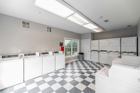 the kitchen has a checkered floor and white appliances
