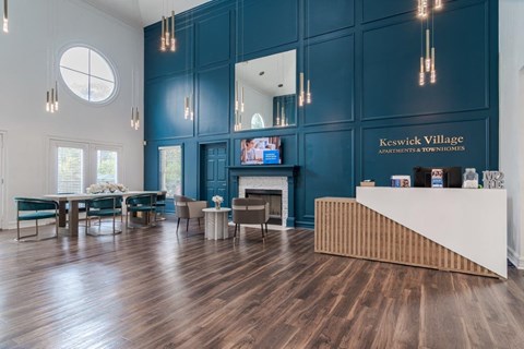 A reception area with a white reception desk and a blue wall.