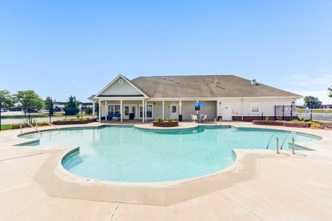 A large swimming pool in front of a building.