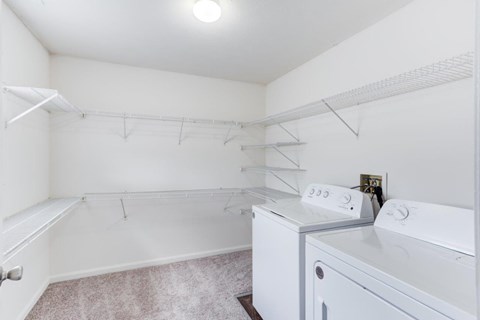 A white laundry room with a washer and dryer.