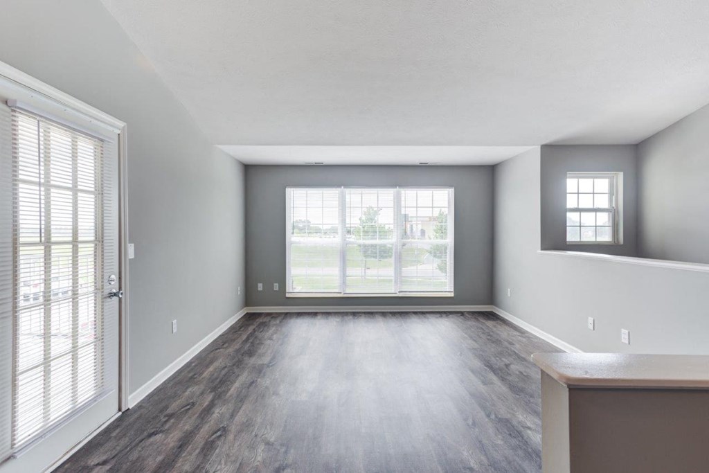 A room with a sliding glass door and a window.