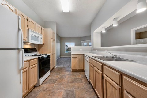 A kitchen with wooden cabinets and a white refrigerator.