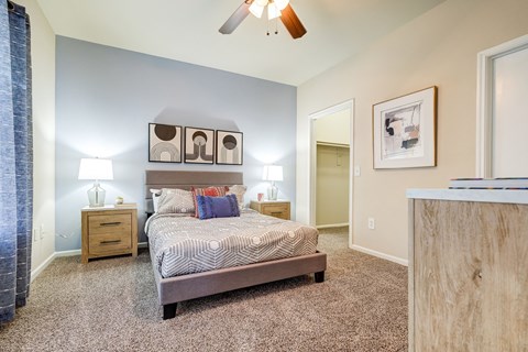 a bedroom with a bed and a ceiling fan