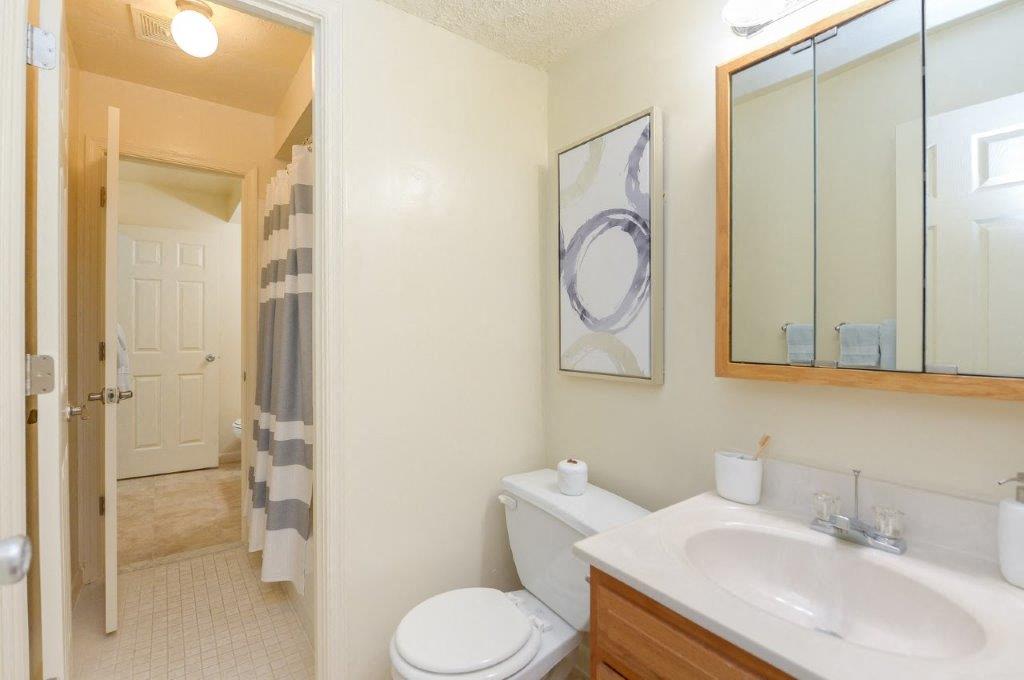 a bathroom with a sink toilet and a mirror