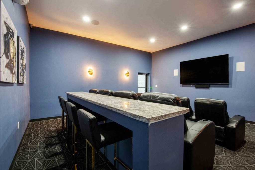 a living room with a bar and a television