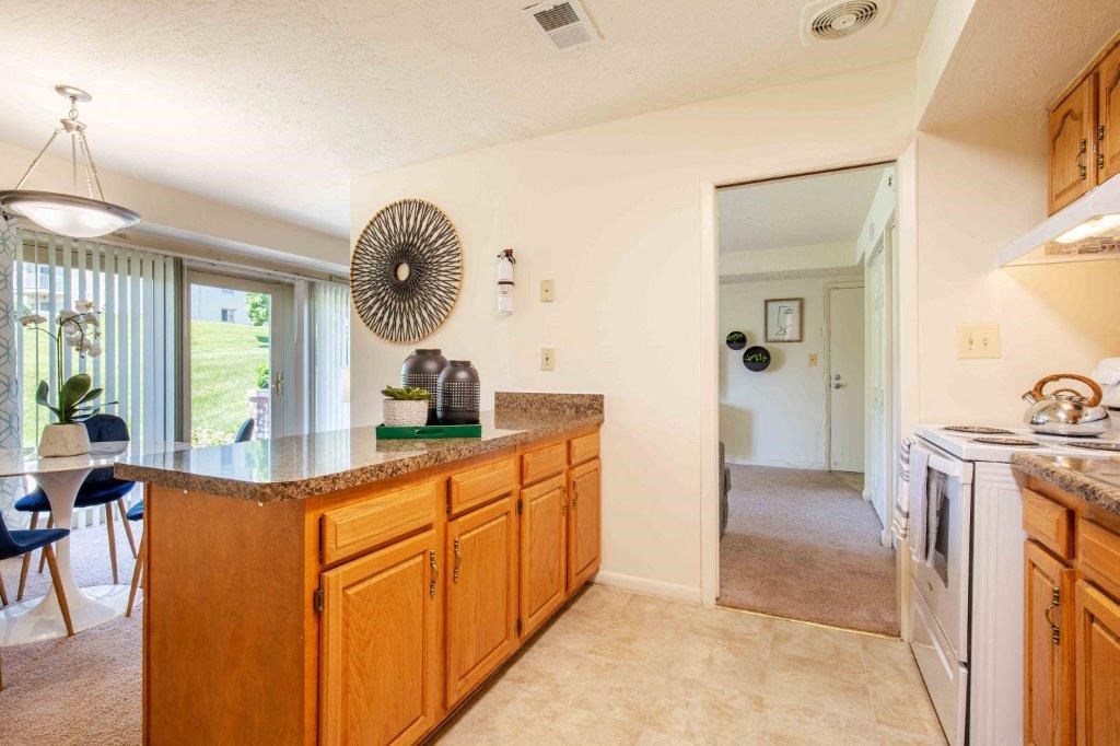 a kitchen with a counter top and a sink    and a living room